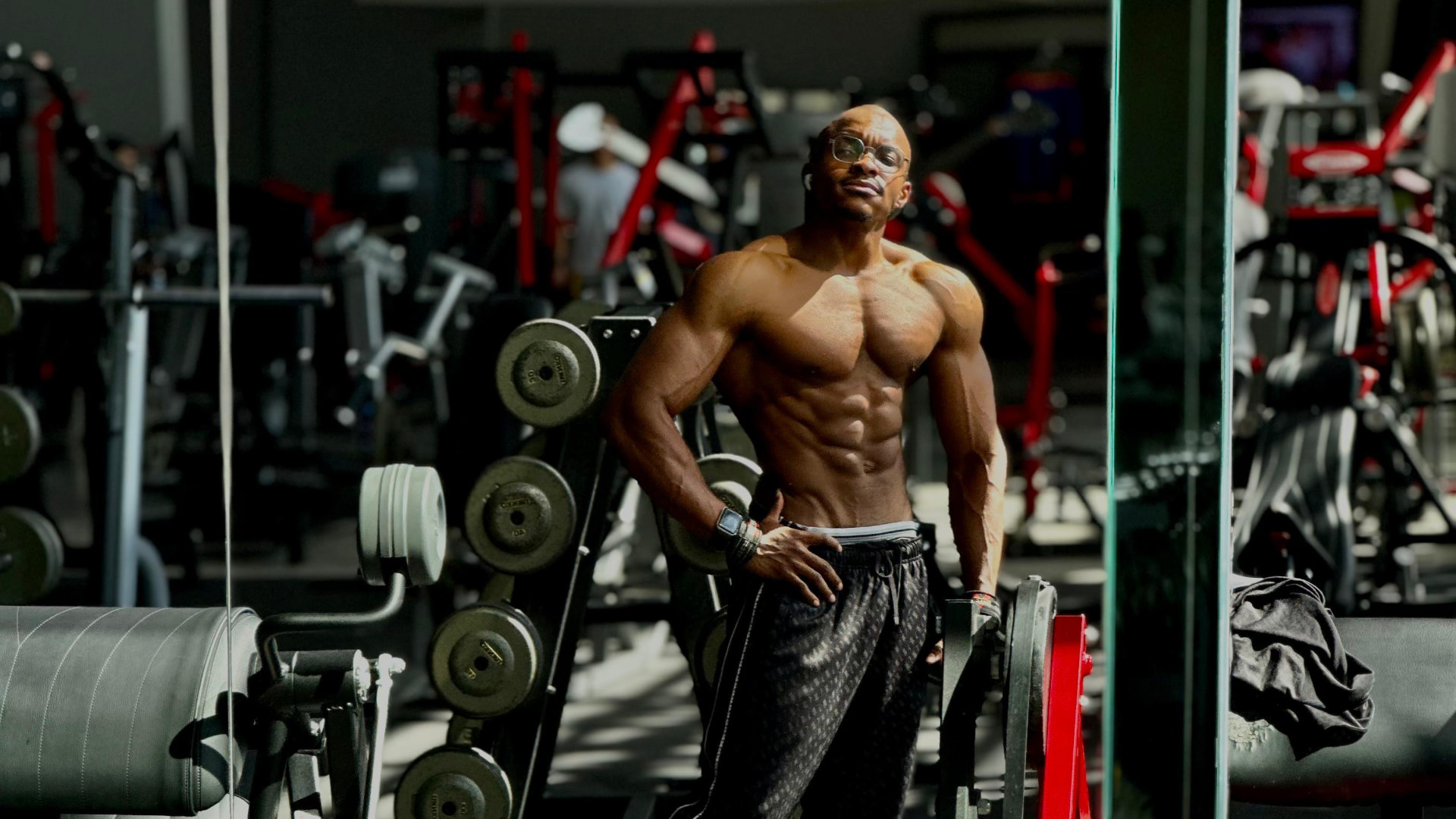 Athlete lifting a barbell under dramatic gym lighting